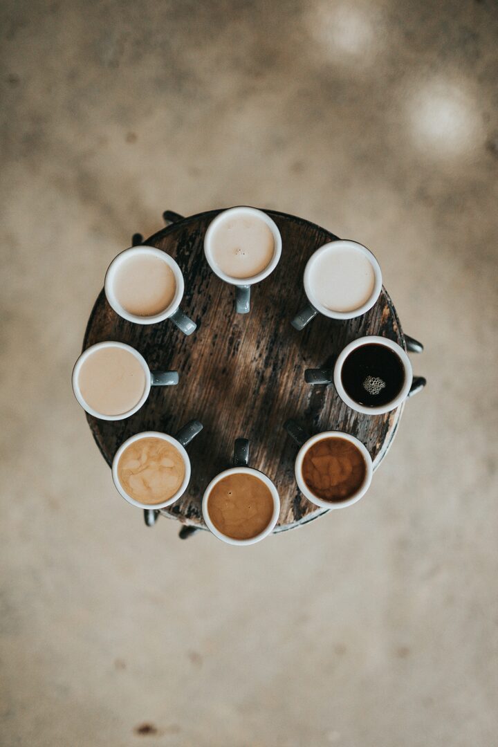 A row of coffee cups at varying strengths and milk levels, every shade represented and treated alike.