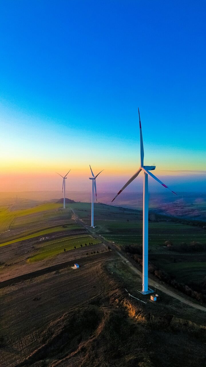 Wind turbines against an open sky, the renewable infrastructure powering Transceve's analysis.